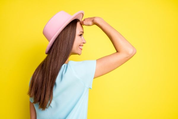 Perfil lateral trasero trasero ver foto de positivo alegre chica viaje descansar relajarse sostener mano cara ver turista anuncios de viernes negro usar ropa rosa aislada sobre fondo de color brillante