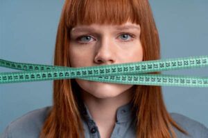i metri a nastro coprono la bocca della giovane donna