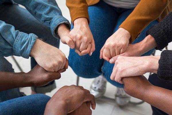 persone in primo piano che si tengono per mano